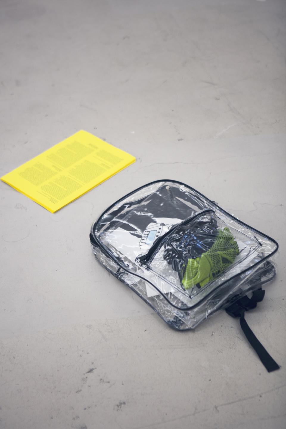 Transparencies: 3 (or 6) Definition..., 2018,Lecture Performance, Essay Draft, Transparent Backpack, Acrylic and Ink on Paper, Work Gloves, Scanning Device Holster